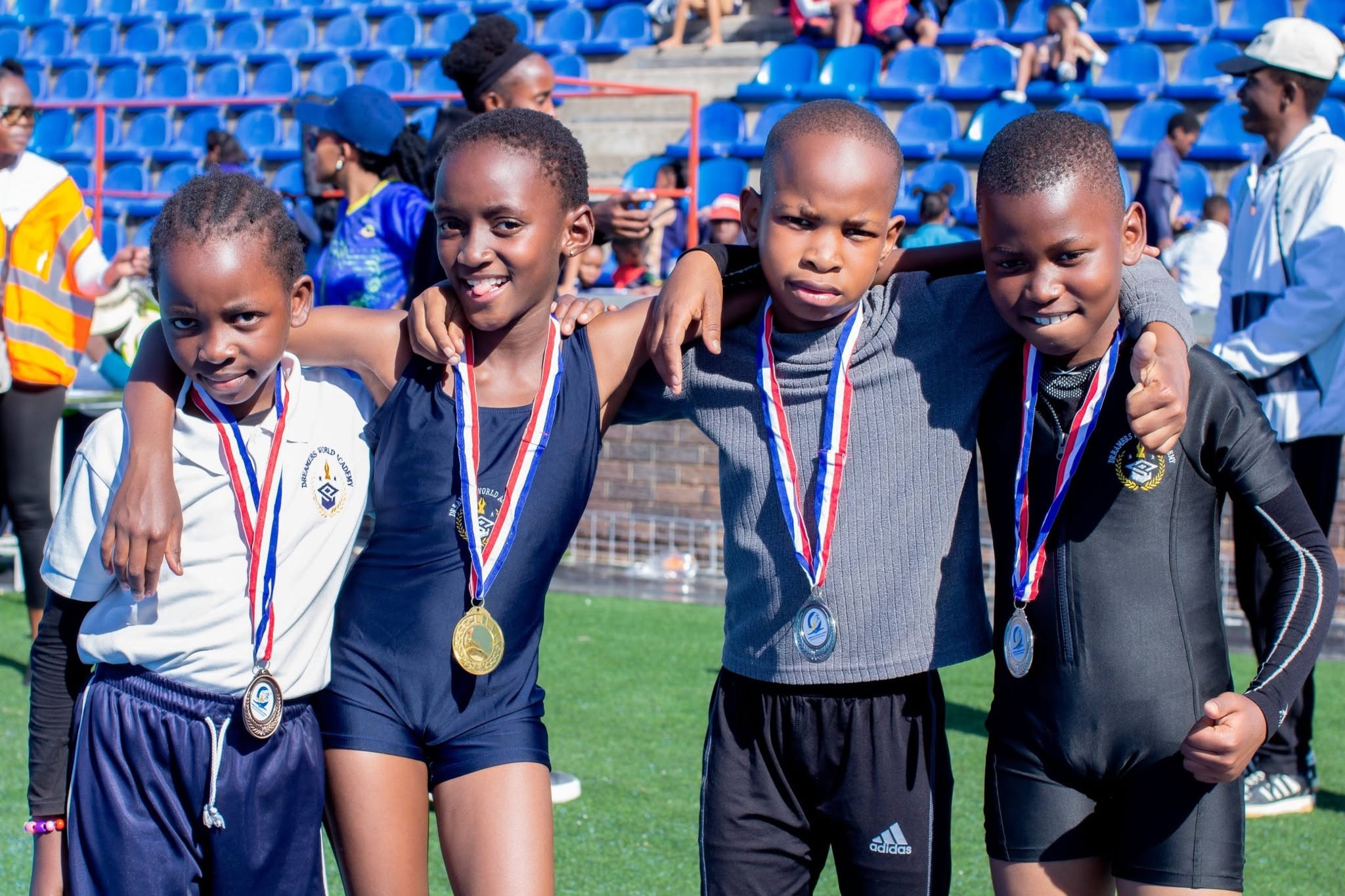 Dreamers World Academy student athletes with medals